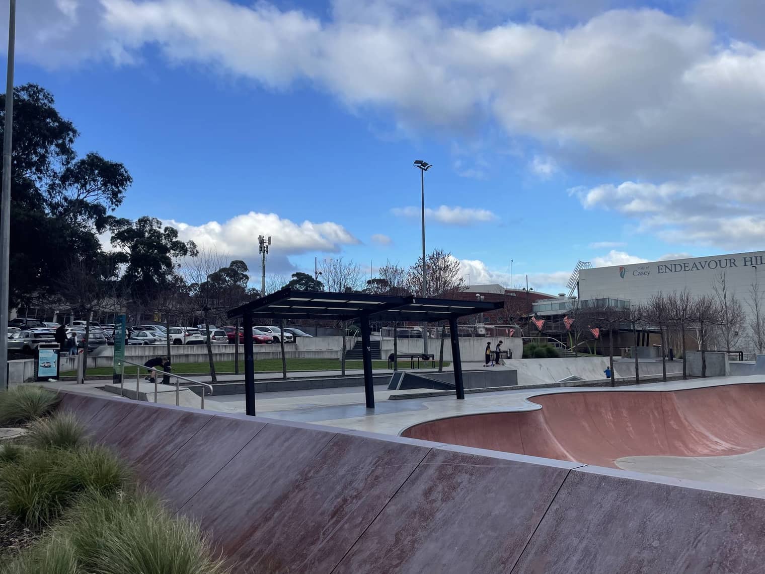 The concrete skate park bowl beside the Leisure Centre, with ramps, rails and a shade shelter.